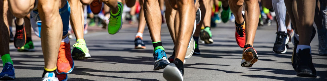 Close-up of runners’ legs during a road race or marathon