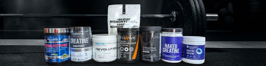 Leading creatine monohydrate brands in a line in front of barbell