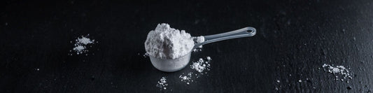 Creatine Monohydrate Scoop on Black Background