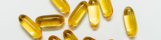 Omega-3 fish oil capsules on a grey background