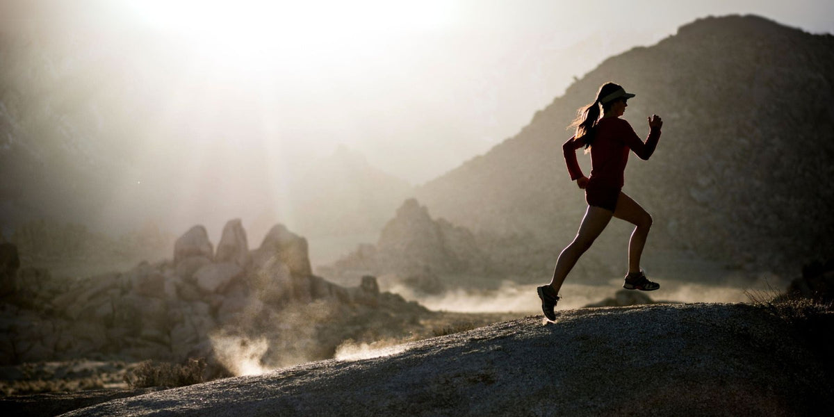 Trail runner at sunrise promoting Thrive Protein’s vegan protein powder, creatine, and electrolytes — Canadian made.