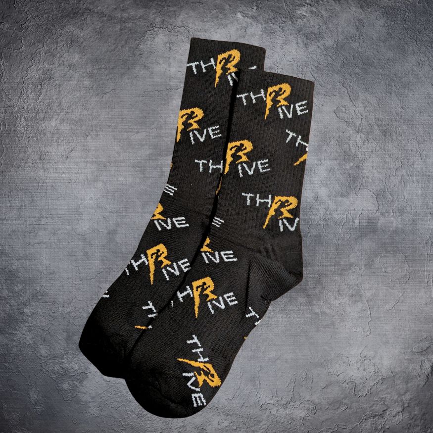 Black Thrive socks with orange and white text on a gray background